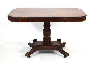 A Regency mahogany, rosewood banded and brass inlaid breakfast table, the tilt-top on a turned