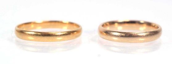 A 22ct yellow gold wedding band, ring size N, 2.2 gms and a yellow metal wedding band, 2.7 gms (2)