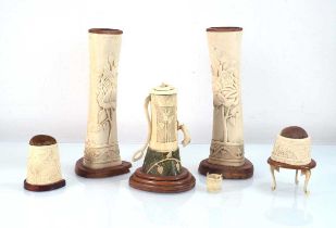 A group of First World War-era bone sculptures including a pair of vases/candlesticks, a water