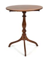 A Georgian mahogany occasional table, the oval surface on a turned baluster column and tripod