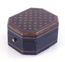 A 19th century ebonised and brass inlaid box of octagonal form, the interior fitted with a miniature