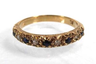 A yellow metal half eternity ring set five small sapphires interspersed with four small diamonds,