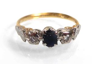 An 18ct yellow gold ring set oval sapphire and two small diamonds in illusion settings, ring size