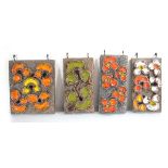 A set of four 1960's Dutch ceramic wall-hung plaques decorated with bright flowers, by Jan Van