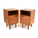 A pair of 1970's teak bedside cabinet, each with a single door, moulded handle and later tapering
