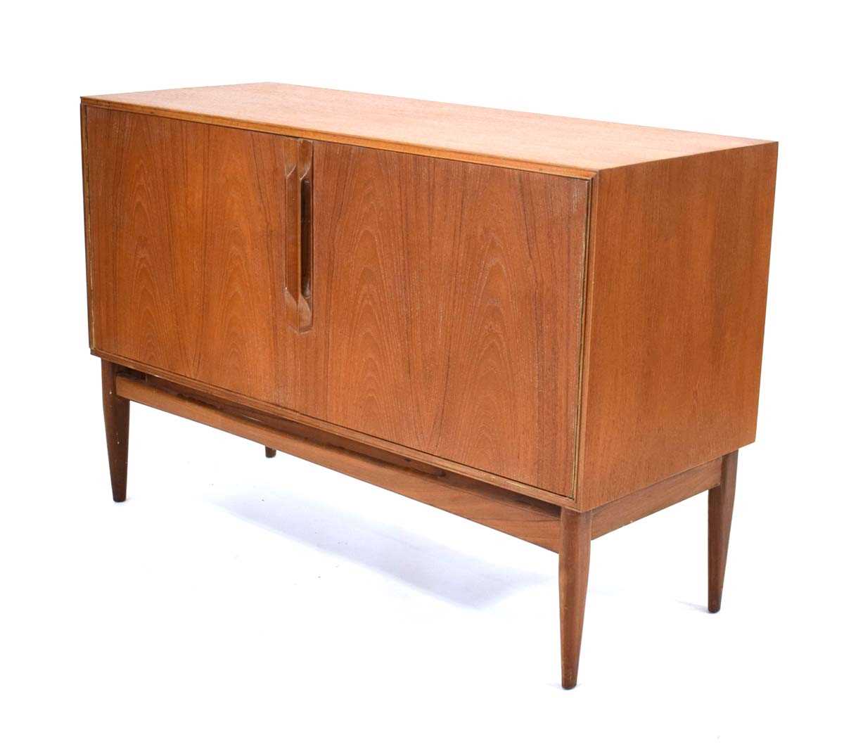 A 1960/70's McIntosh Furniture teak sideboard, the two doors with moulded handles, on triangular