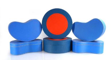 A pair of Jonathan Adler circular leatherette boxes, di. 23 cm, together with four kidney-shaped