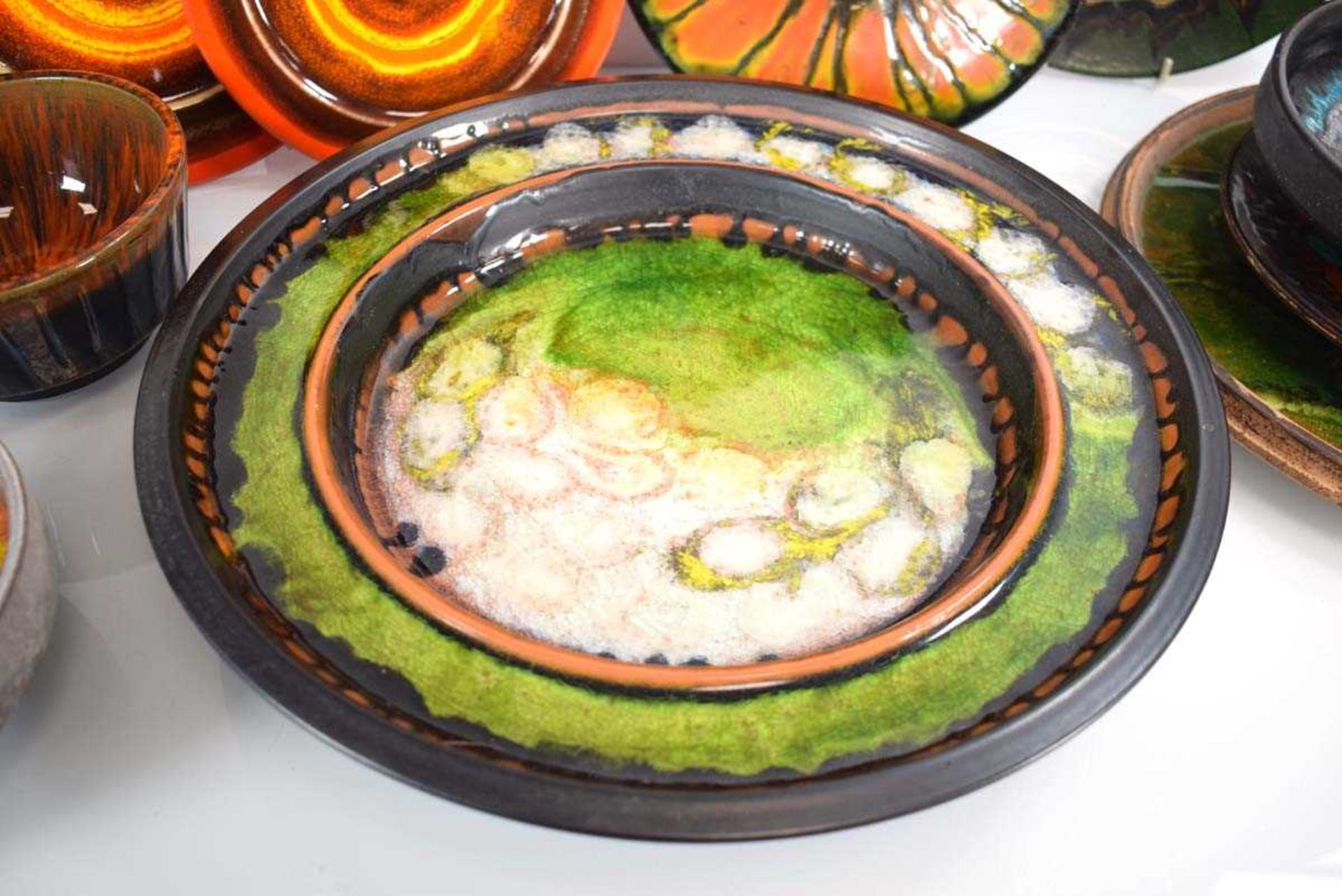 A group of 1960's German, Hungarian and other chargers and bowls decorated in bright glazes, - Image 2 of 3