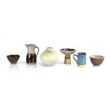 A group of six British studio pottery pieces including a jug by Richard Cheshire, a vase by A. Hardy