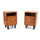 A pair of 1970's teak single door bedside cabinets with circular handles and stainless decoration,