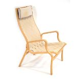 A 1960's Danish beech bentwood armchair with a webbed seat, designed by Finn Ostergaard