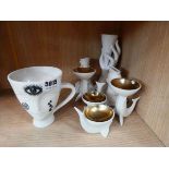 A group of white ceramic decorative objects including an 'Inked Giuliette Mug', accent dishes