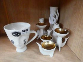 A group of white ceramic decorative objects including an 'Inked Giuliette Mug', accent dishes