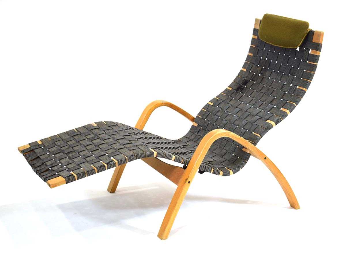 A 1960's Ikea 'Axstad' lounge chair designed by Kim Samson, the beech frame supporting a webbed seat