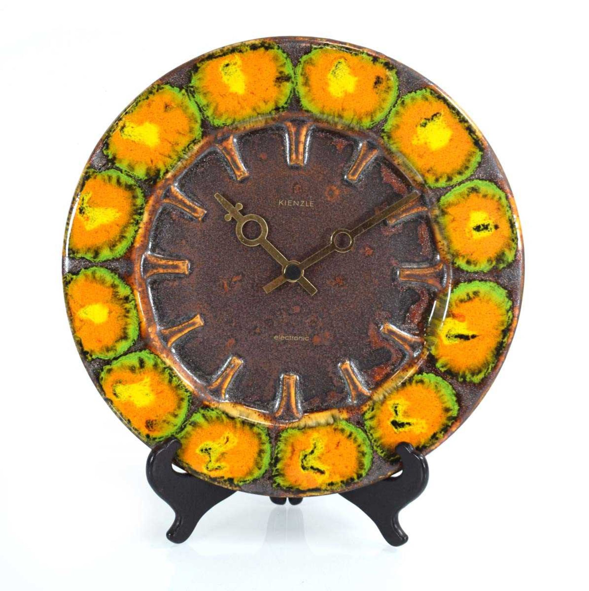 A German pottery wall clock with orange and green glazes by Kienzle, di. 30 cm clock is battery