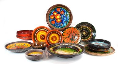 A group of 1960's German, Hungarian and other chargers and bowls decorated in bright glazes,