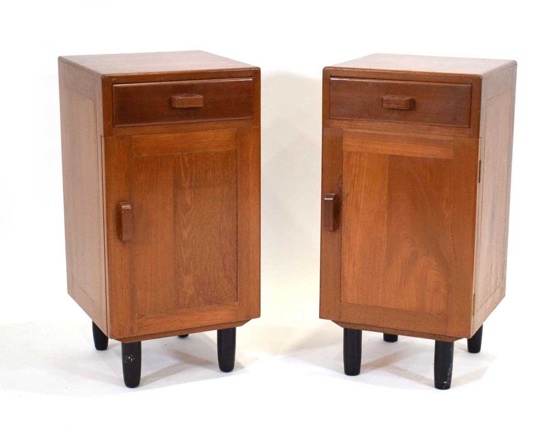 A pair of 1950/60's solid teak bedside cabinets with cardboard drawer liners and chunky handles,