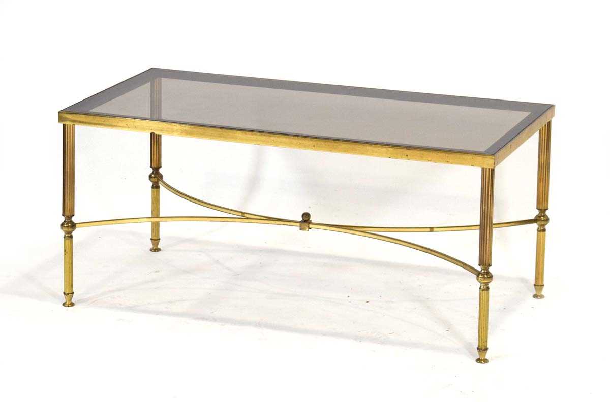 A 1980's brass finished coffee table with a rectangular smoked glass surface and reeded legs in