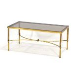 A 1980's brass finished coffee table with a rectangular smoked glass surface and reeded legs in