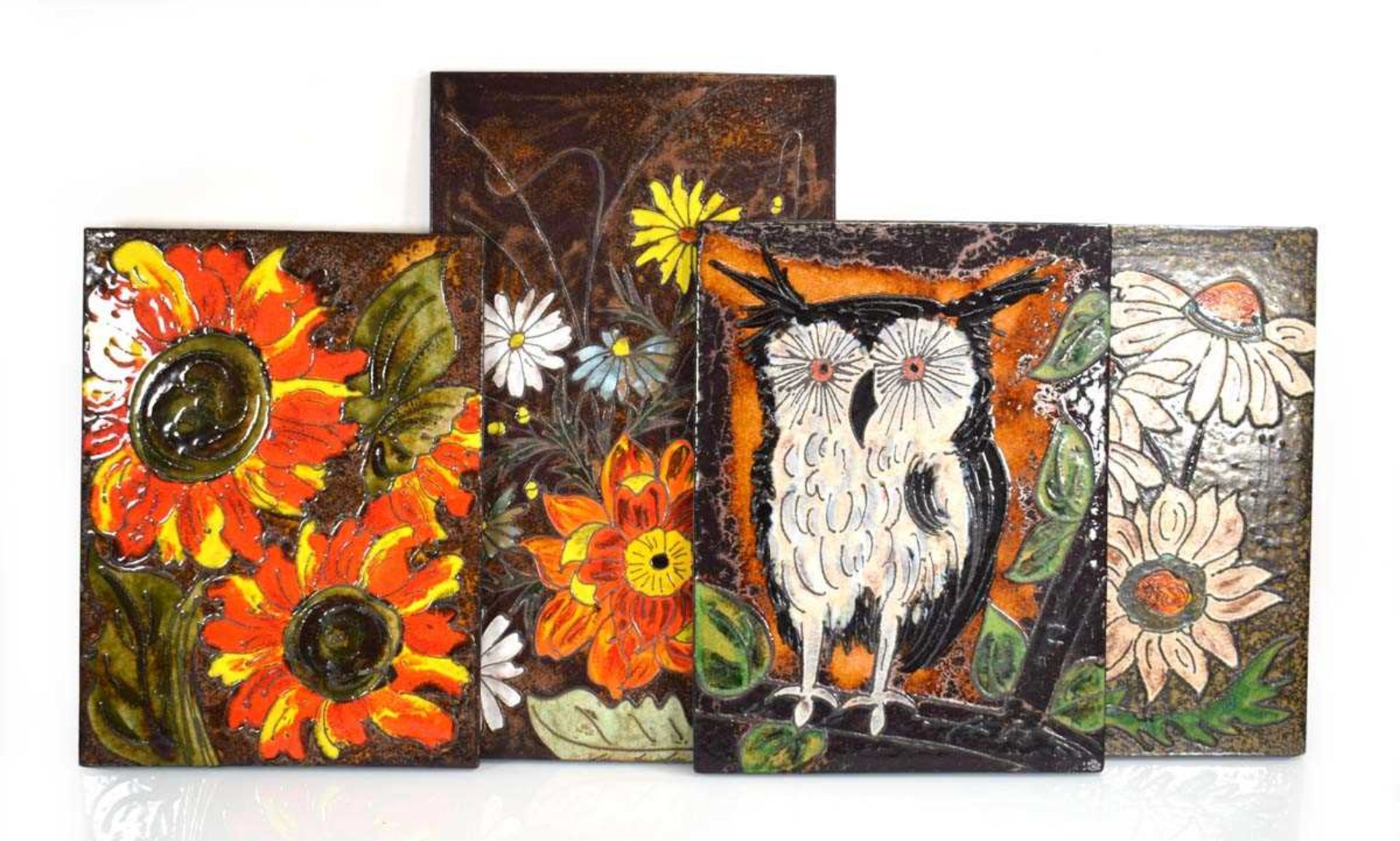 A group of four 1960's German ceramic wall plaques decorated with flowers and an owl, by Ruscha