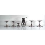 A group of Robert Welch stainless steel tablewares including four tazzas, a candlestick and a