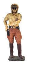 A live-size fibreglass figure modelled as an American Police officer wearing a motorcycle helmet and
