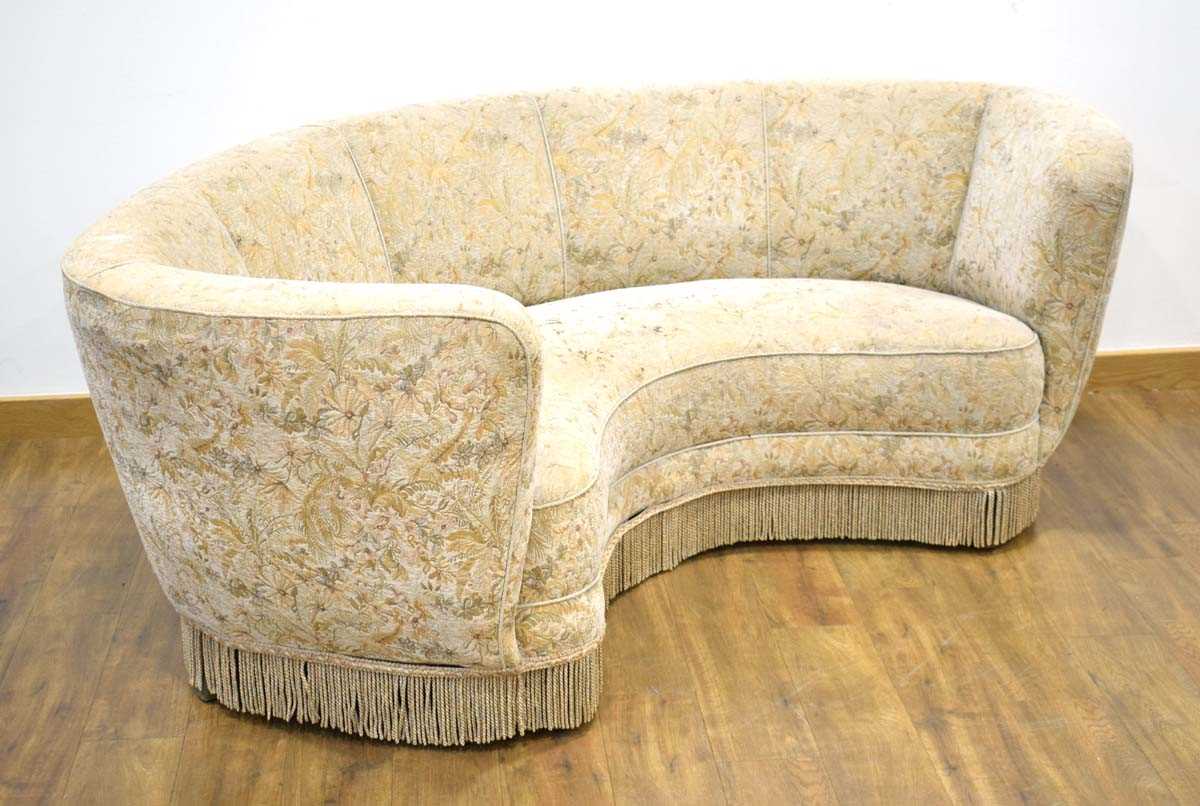 A 1950's Danish corner or 'Banana' sofa upholstered in cream floral fabric