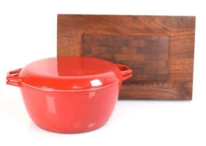 A Danish red enamelled casserole dish and cover by Nacco, di. 29 cm, together with a teak cooling