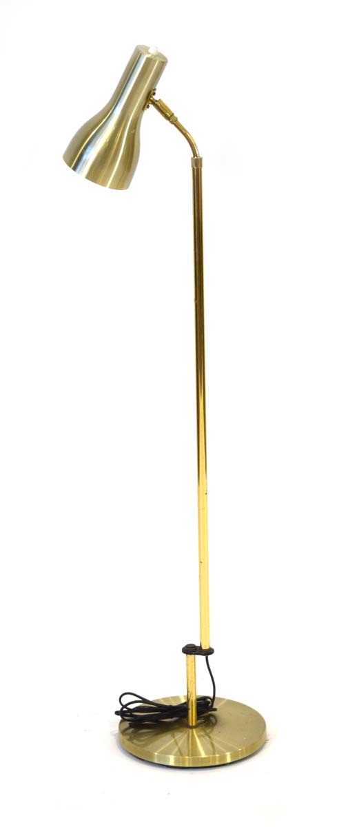 A 1970's Danish half-height brass-finished adjustable standard lamp Lead cut, working order unknown,