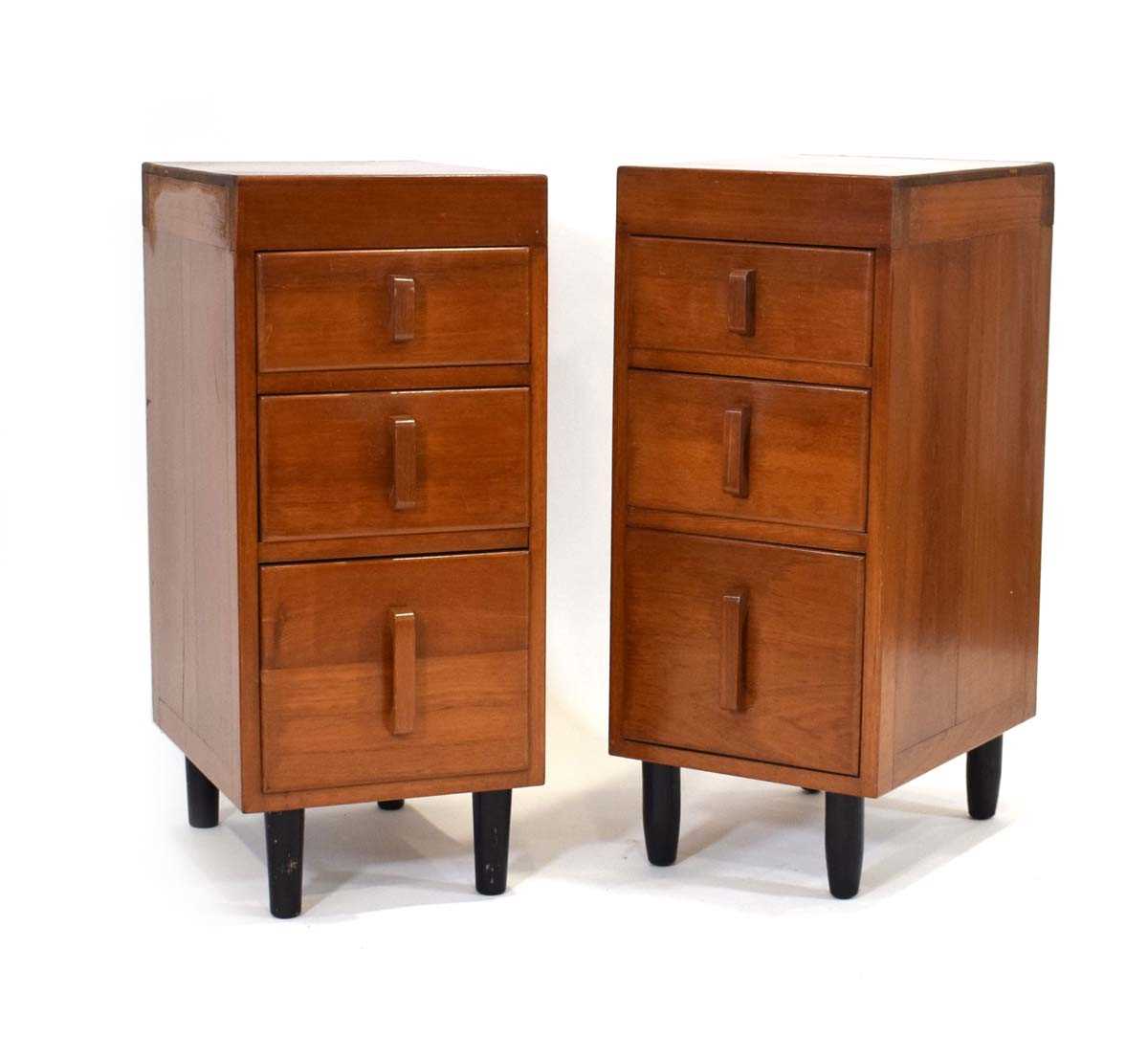 A pair of 1950/60's solid teak three-drawer side cabinets with cardboard drawer liners and chunky