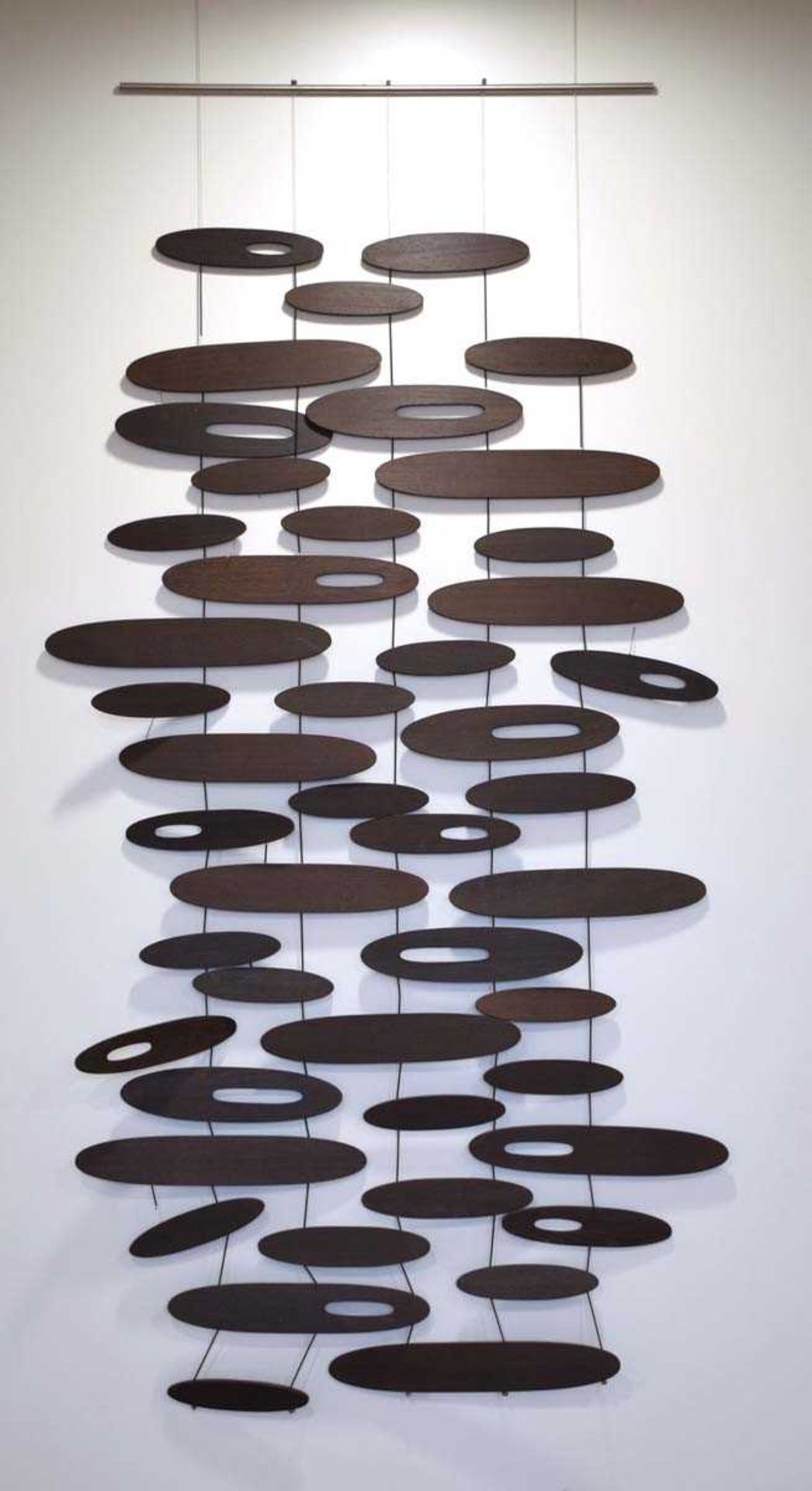 A contemporary Italian wall hanging with black ash 'pebbles', labelled 'Inartemvertere by I. & S.