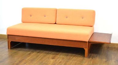 A 1960/70's teak daybed, the orange button-upholstered seat with two loose back cushions, the side