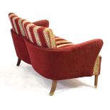 A 1960's Danish two-seater sofa or loveseat with a 'wrap-around' frame, on beech tapering legs *Sold