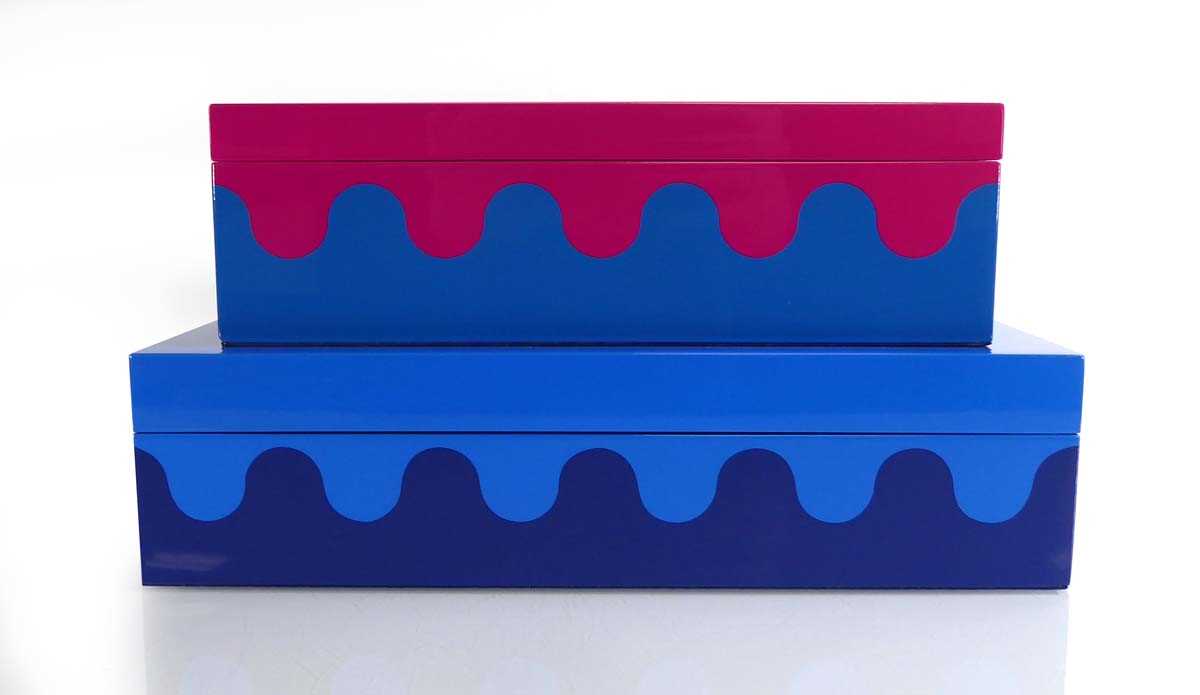 A graduated pair of Jonathan Adler boxes in purple and blue with wave decoration, 30 x 20 x 8 cm and
