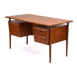 A 1960's Danish teak and crossbanded desk, the rectangular surface over 'levitating' pedestals and