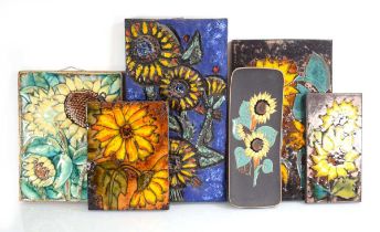 A group of six 1960's ceramic wall plaques depicting sunflowers, by Ruscha and others (6)