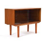 A 1960/70's teak cabinet with two glazed sliding doors, on later turned legs, 76 x 26 x 59 cm