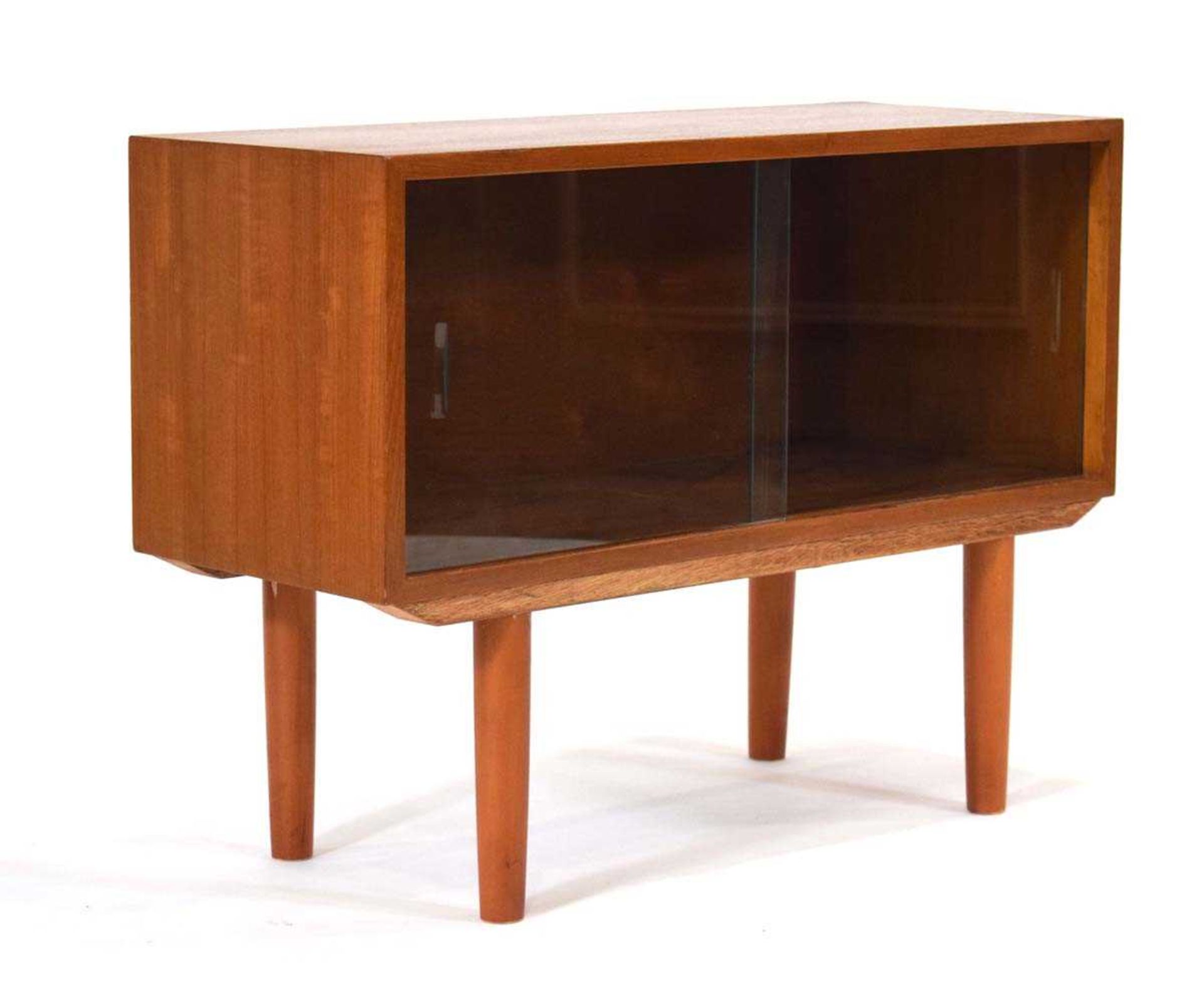 A 1960/70's teak cabinet with two glazed sliding doors, on later turned legs, 76 x 26 x 59 cm