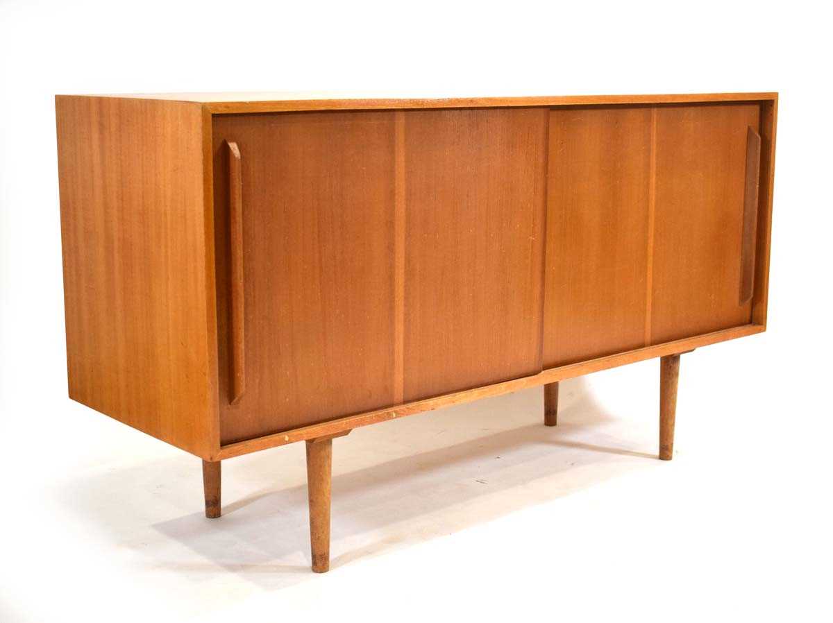 A 1950s Hilleplan sideboard designed by Robin Day, the two sliding doors enclosing shelves and