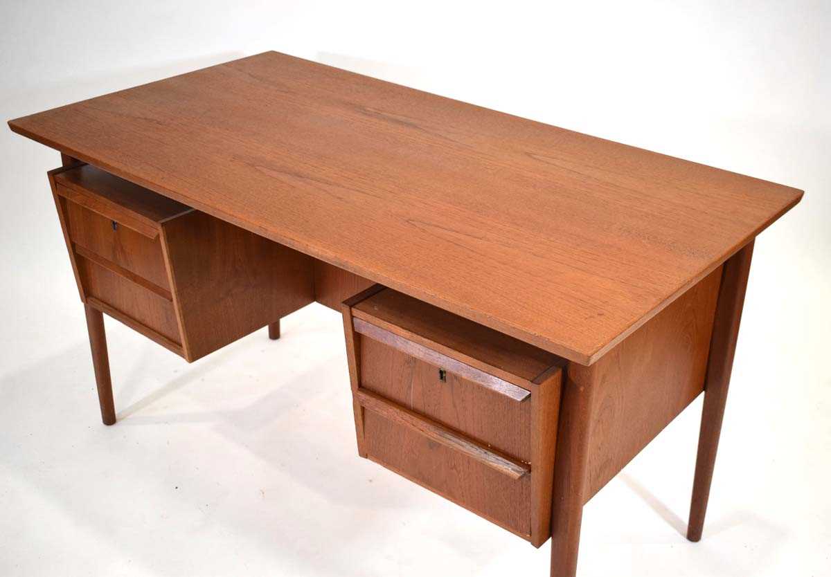 A 1960's Danish teak and crossbanded desk, the rectangular surface over 'levitating' pedestals and - Image 2 of 4
