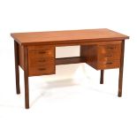 A 1960's Danish teak and crossbanded kneehole desk, the rectangular surface over six drawers with an