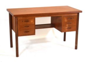 A 1960's Danish teak and crossbanded kneehole desk, the rectangular surface over six drawers with an