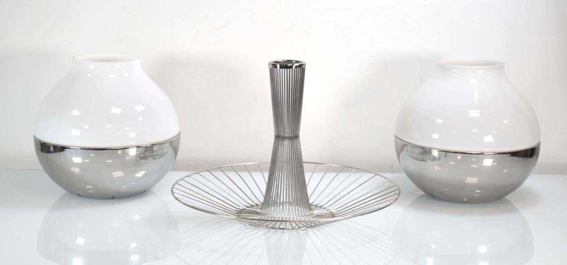 A Georg Jensen 'Barbry' wire basket together with a pair of 'Henning Koppel' hurricane lamps (3)