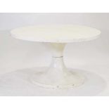 A 1960/70's fibreglass table, the white surface resting on an hour-glass shape base, di. 120 cm