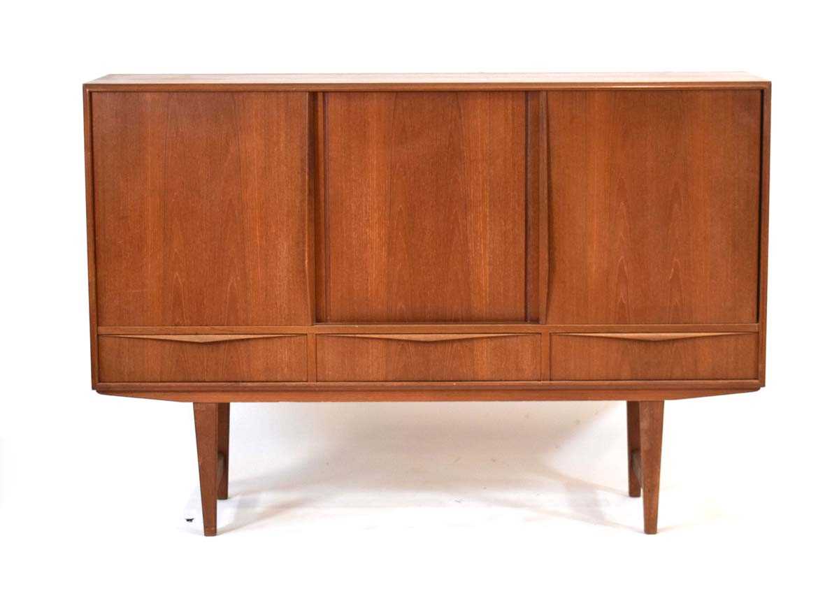 E W Bach for Sejling Skabe, a 1960's Danish teak sideboard with three sliding doors enclosing