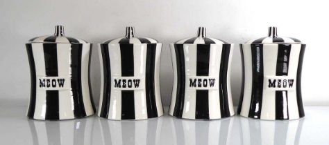 A set of four Jonathan Adler ceramic biscuit barrels decorated in black and white with 'Meow'