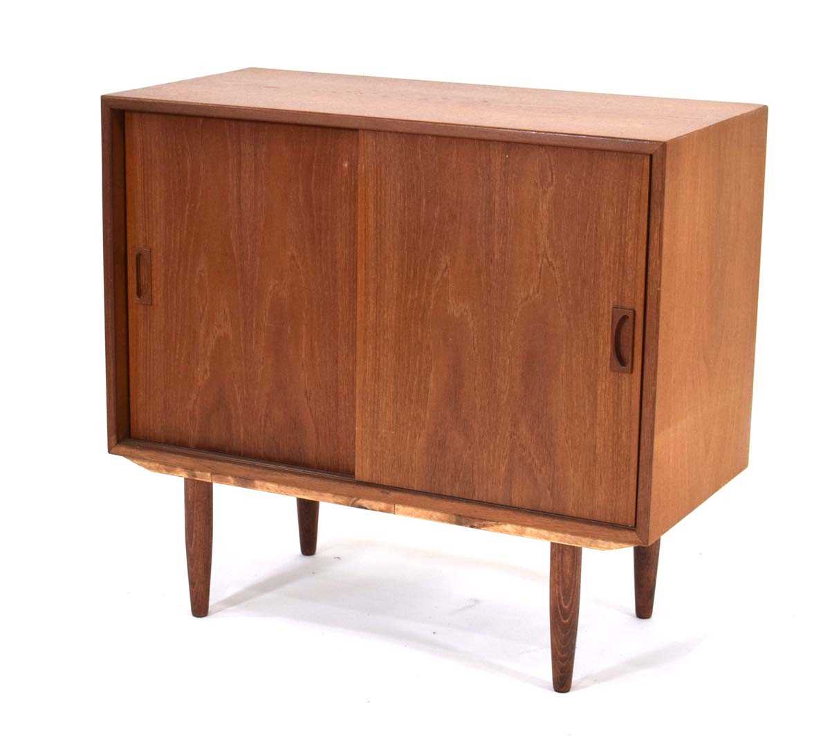 A 1960's Danish teak cabinet with two sliding doors enclosing a single shelf, on later turned