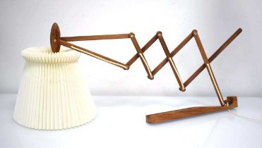 A Le Klint 'Sax' wall lamp with teak scissor arm, designed by Erik Hansen