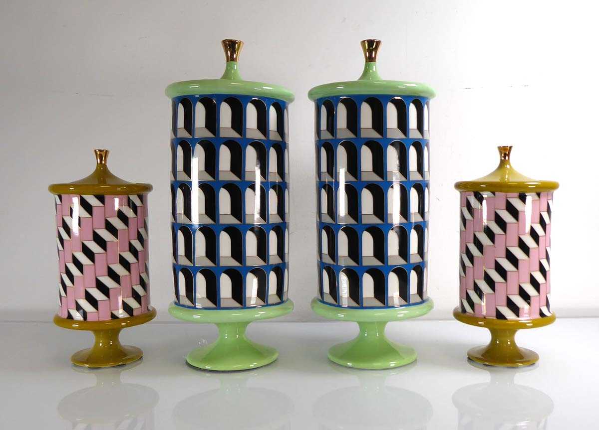 A pair of Jonathan Adler ceramic cylindrical footed cannisters, h. 38 cm, together with a smaller