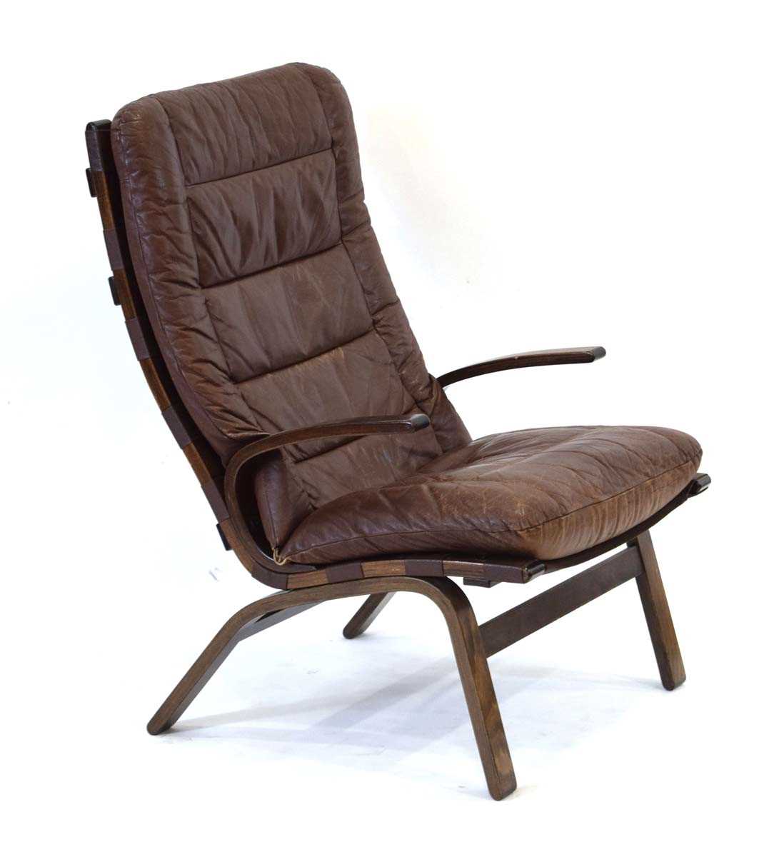 In the manner of Ingmar Relling, a 1960's Danish lounge armchair with a laminate frame and brown